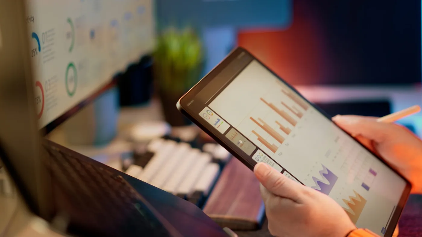Business owner reviewing a performance dashboard on a tablet
